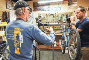 Aaron Linn repairs a bike