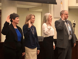 Susan Funk, along with other newly elected city officials, are sworn in